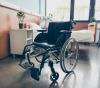 Empty wheelchair and hospital bed