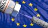 COVID vaccine vial and syringe in front of EU flag