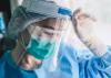 Exhausted nurse in full PPE
