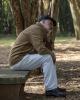 Tired older man on park bench