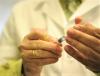 Flu vaccine syringe in doctor's hands