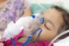 Girl in hospital wearing oxygen mask