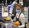 Grocery store cashier wearing mask