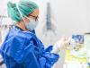 Healthcare worker putting on personal protective equipment