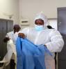 Healthcare workers in South Africa putting on protective equipment