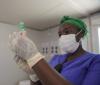 Healthcare worker drawing COVID vaccine into syringe