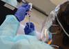 Healthcare worker filling COVID vaccine syringe