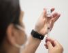 Vaccine in a vial syringe.