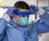 Health worker with respirator and face shield