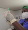 Health worker holding COVID-19 vaccine vial