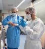 Health workers putting on their PPE