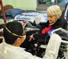 Health worker with resident of nursing home