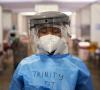 Healthcare worker wearing respirator, face shield