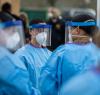 Health workers wearing N95s and face shields