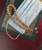 A Koran, mask, and prayer beads