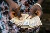 Liberian paper money in a person's hands.