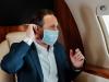 Man taking mask off on plane