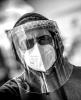 Man wearing respirator, face shield