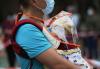 Man with baby in line for COVID testing