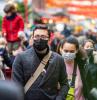 People wearing masks on busy street