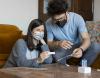 Masked couple checking at-home COVID test results