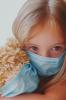 Masked girl with masked teddy bear