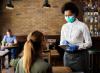 Masked waitress taking order