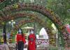 Masked women under flowered archways