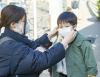 Mom putting mask on young son
