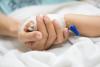 Mother holding child's hand in the hospital