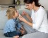 Mother swabbing child for rapid COVID-19 test