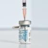 Needle inserted into Pfizer COVID vaccine vial