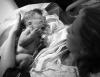Newborn with mom and umbilical cord clamp