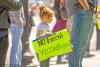 Girl with 'no forced vaccinations' sign