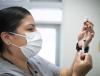 Nurse drawing vaccine into syringe