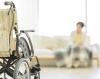 Nursing home resident, blurred, and empty wheelchair