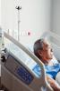 Older Asian man in hospital bed