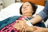 Older Asian woman in a hospital bed