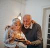 Older couple blowing out birthday candles