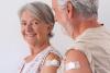 Older couple with vaccine bandages on their arms