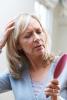 Older woman checking for hair loss