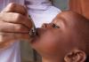 Child receiving oral polio vaccine