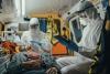 Paramedics in full PPE in ambulance