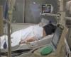 Patient lying prone in hospital bed