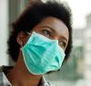 Pensive Black woman wearing mask