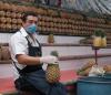Pineapple seller wearing mask
