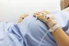 Pregnant belly of woman in hospital bed