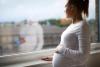 Pregnant woman at window