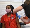 Prepping woman's arm for COVID shot