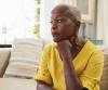 Senior woman sitting alone at home